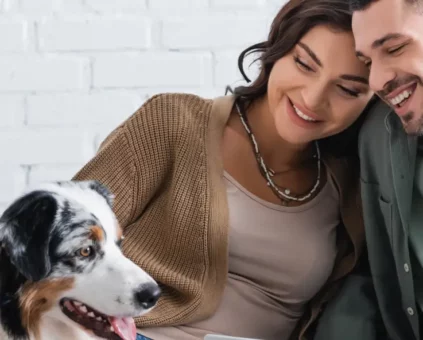 Happy young couple smiling with pet dog